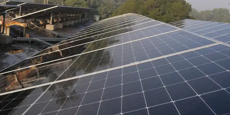 Solar panels mounted at an angle on a flat roof.